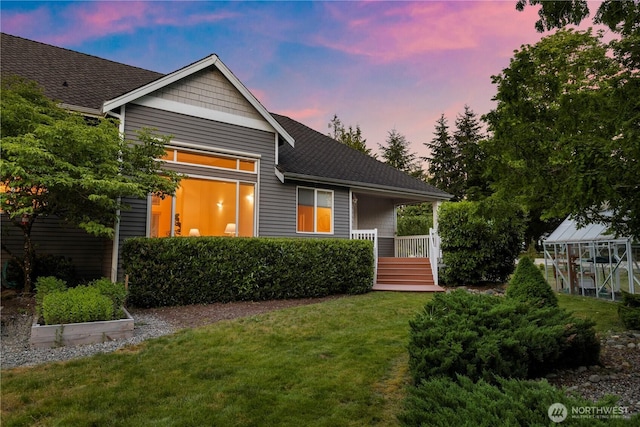 17605 244th Ave SE, Maple Valley, WA 98038 - view of front of property featuring a front lawn, an exterior structure, a shingled roof, and an outdoor structure