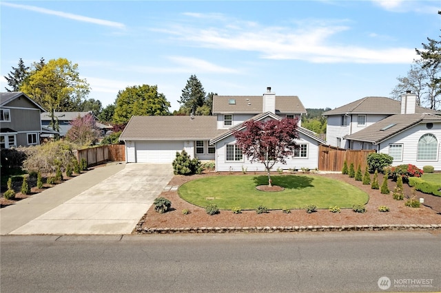 view of front of home featuring fence, driveway, a front lawn, and a garage