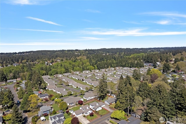aerial view featuring a wooded view and a residential view
