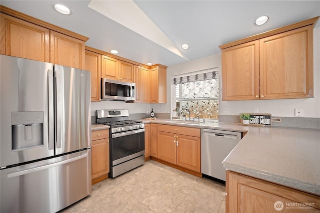 kitchen with recessed lighting, light tile patterned floors, stainless steel appliances, vaulted ceiling, and a sink
