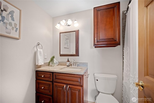 full bath featuring toilet and vanity