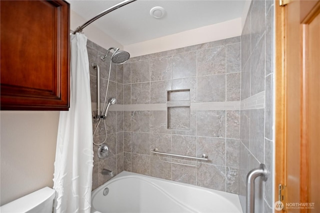 bathroom with shower / bath combo with shower curtain and toilet