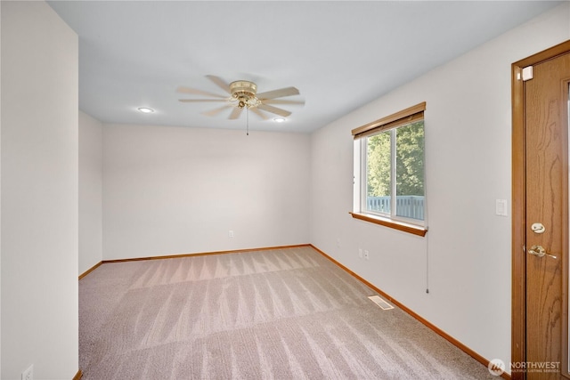 unfurnished room with visible vents, ceiling fan, carpet flooring, and baseboards