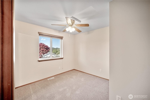 empty room with a ceiling fan, carpet flooring, baseboards, and visible vents