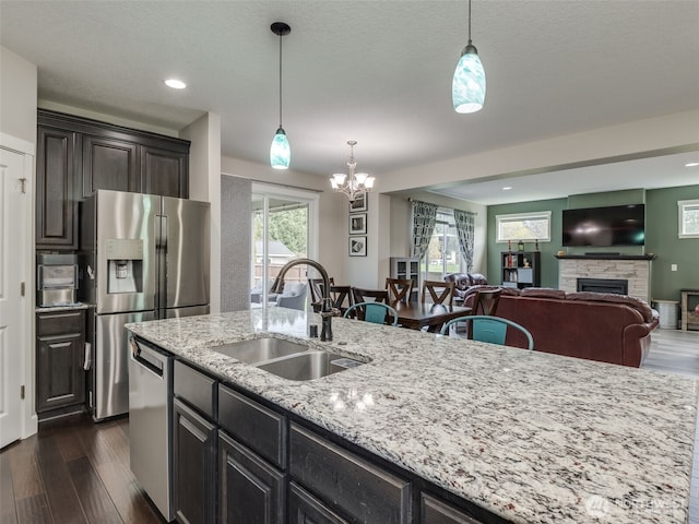4206 NE 132nd St, Vancouver, WA 98686 - kitchen featuring stainless steel appliances, a sink, dark wood-style flooring, a chandelier, and a fireplace