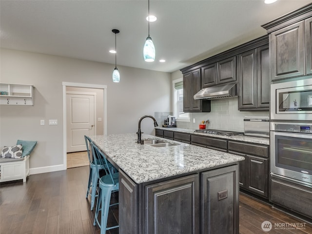 4206 NE 132nd St, Vancouver, WA 98686 - kitchen featuring stainless steel appliances, a kitchen island with sink, dark wood-style floors, a sink, and under cabinet range hood