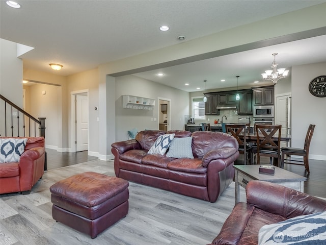 4206 NE 132nd St, Vancouver, WA 98686 - living area with light wood-type flooring, baseboards, stairway, and an inviting chandelier