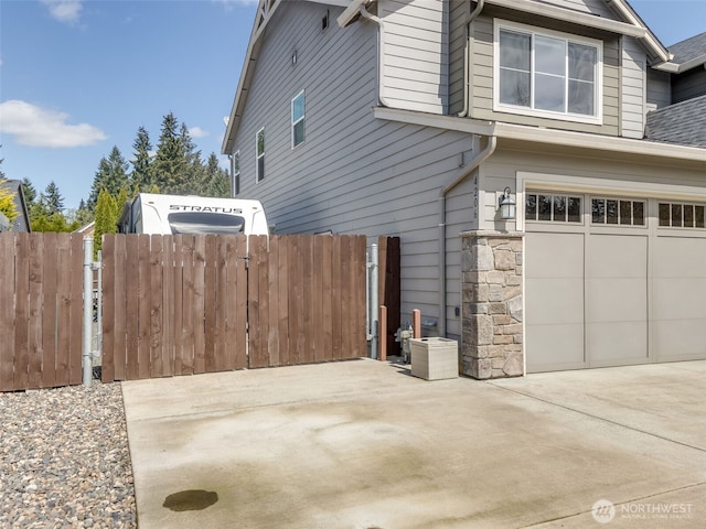 4206 NE 132nd St, Vancouver, WA 98686 - view of side of property featuring an attached garage, central AC, fence, and driveway