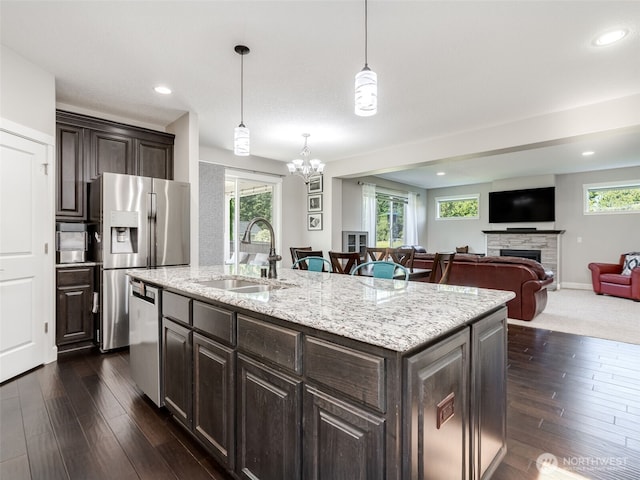 4206 NE 132nd St, Vancouver, WA 98686 - kitchen with a sink, stainless steel appliances, dark brown cabinets, a fireplace, and plenty of natural light