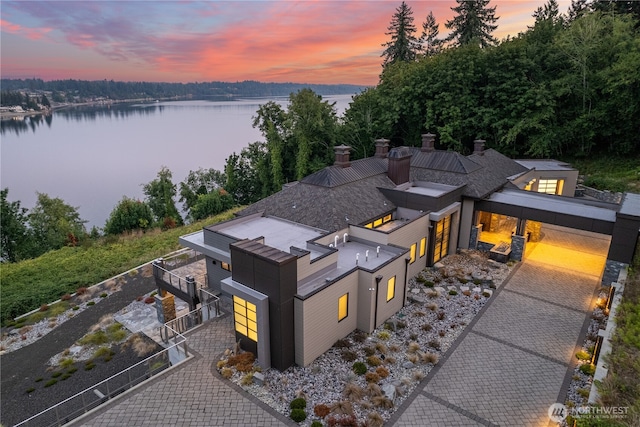 aerial view at dusk with a water view