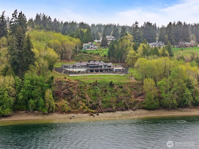 exterior space featuring a water view and a forest view