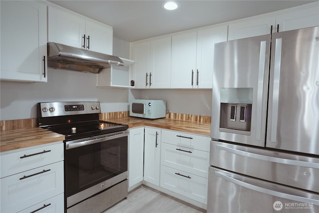 12501 50th Pl S, Seattle, WA 98178 - kitchen featuring white cabinets, recessed lighting, wood counters, under cabinet range hood, and appliances with stainless steel finishes