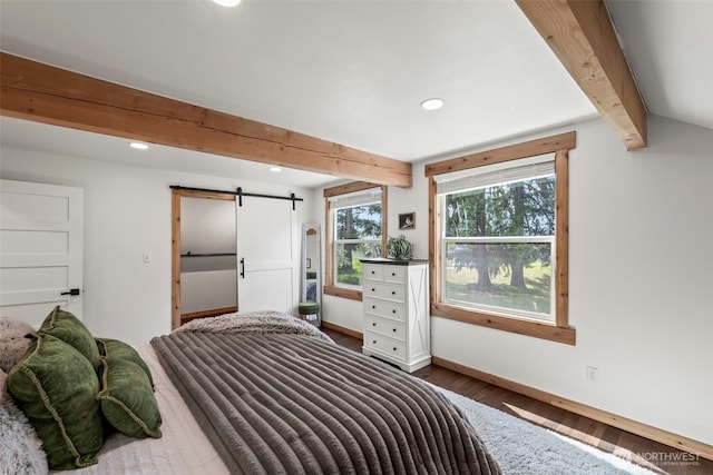 bedroom with a barn door, wood finished floors, baseboards, beam ceiling, and recessed lighting
