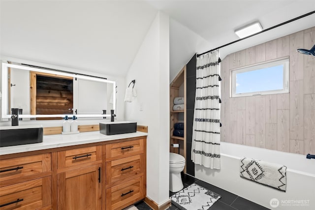 bathroom with vaulted ceiling, tile patterned floors, vanity, shower / bathtub combination with curtain, and toilet