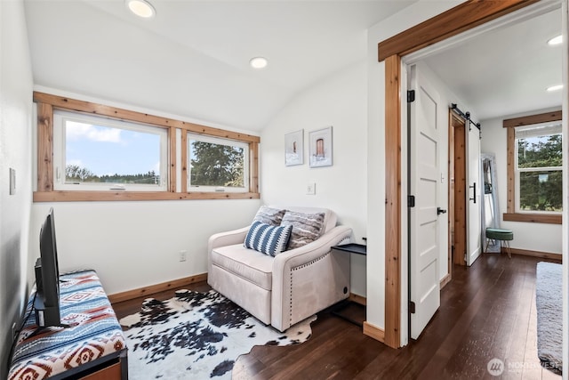 sitting room with a barn door, recessed lighting, lofted ceiling, baseboards, and dark wood-style flooring
