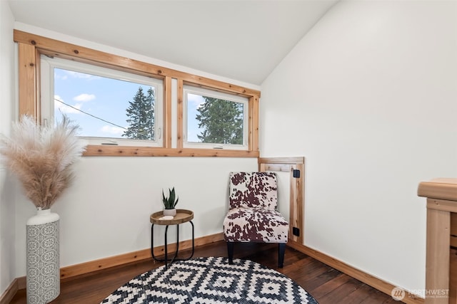 sitting room with wood finished floors, lofted ceiling, and baseboards