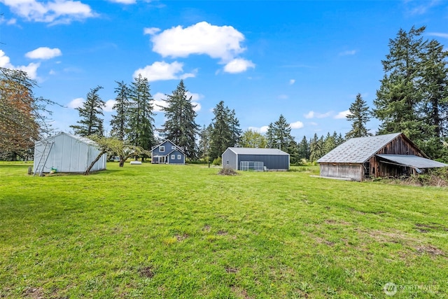 view of yard with an outdoor structure and an outbuilding