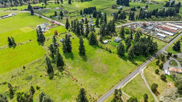 birds eye view of property with a rural view