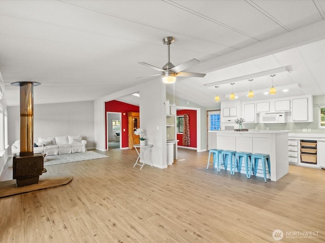 5255 Apollo Rd, Langley, WA 98260 - living area with lofted ceiling with beams, light wood finished floors, a ceiling fan, and baseboards