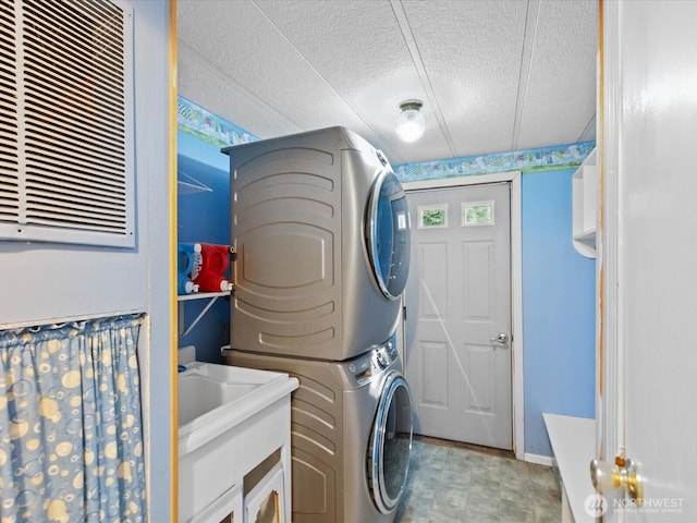 5255 Apollo Rd, Langley, WA 98260 - washroom featuring stacked washer and clothes dryer, a textured ceiling, and laundry area
