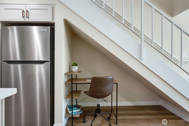 interior space with wood finished floors and baseboards