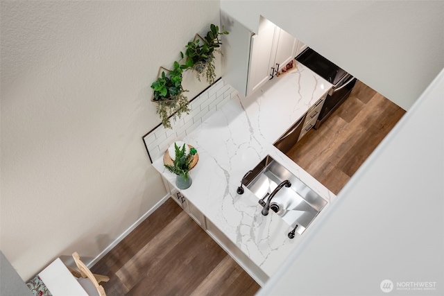 stairway featuring wood finished floors and baseboards