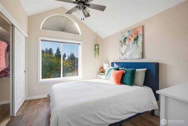bedroom with a closet, lofted ceiling, baseboards, and wood finished floors