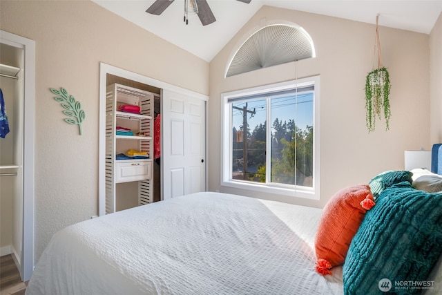 bedroom with a closet, vaulted ceiling, a ceiling fan, and wood finished floors