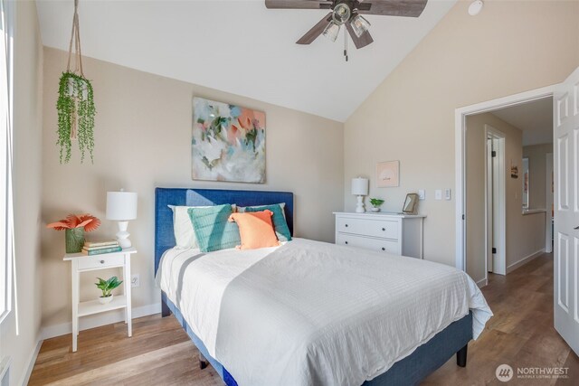 bedroom with baseboards, vaulted ceiling, light wood-style flooring, a ceiling fan, and visible vents