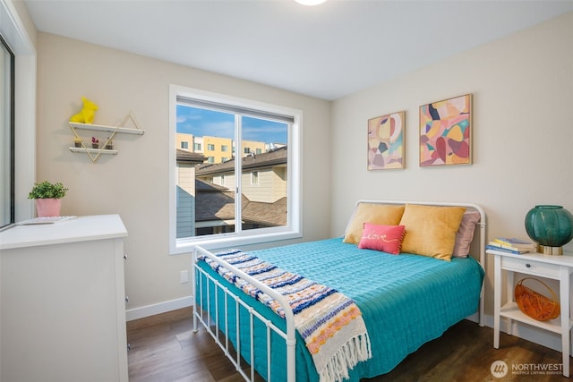bedroom featuring wood finished floors and baseboards
