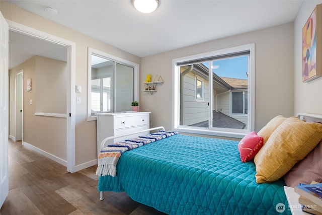 bedroom with baseboards and wood finished floors