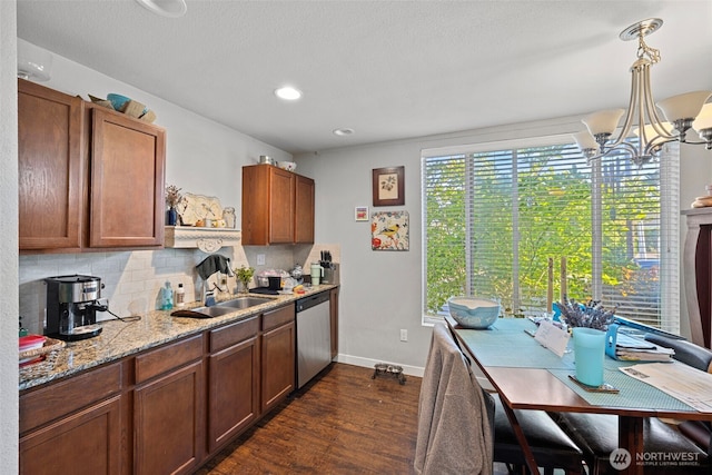 1713 17th St, Everett, WA 98201 - kitchen featuring stainless steel dishwasher, an inviting chandelier, dark wood-style floors, baseboards, and backsplash