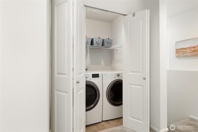 washroom featuring washing machine and dryer and laundry area