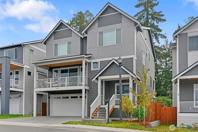 view of front of property with an attached garage, fence, and aphalt driveway
