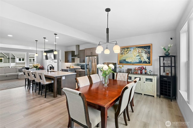 dining space featuring recessed lighting and light wood-style flooring