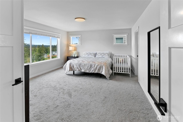 bedroom with baseboards and carpet