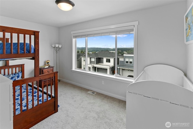 bedroom featuring baseboards, carpet, and visible vents