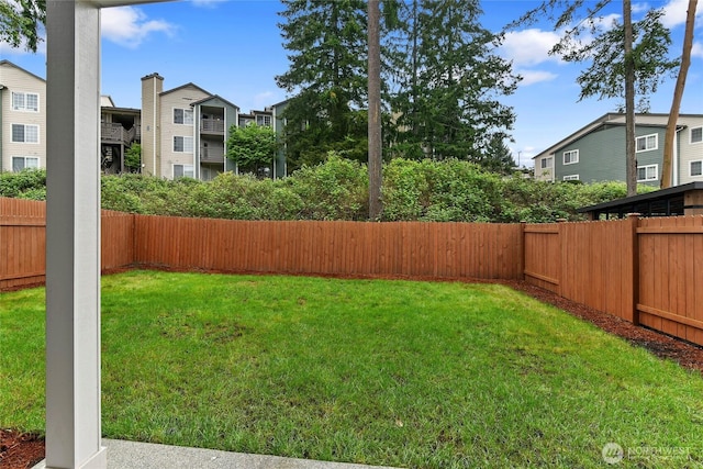 view of yard featuring a residential view and a fenced backyard