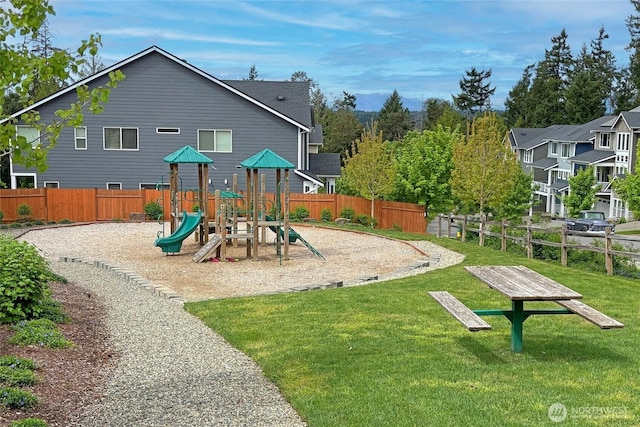 view of play area with a lawn and fence