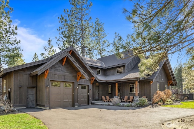 70 Monabel Ct, Cle Elum, WA 98922 - view of front facade featuring a shingled roof, driveway, board and batten siding, and an attached garage