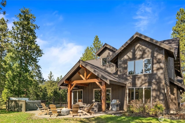 70 Monabel Ct, Cle Elum, WA 98922 - back of property with a patio, board and batten siding, and an outdoor fire pit