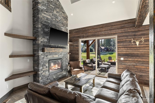 70 Monabel Ct, Cle Elum, WA 98922 - living area with visible vents, a high ceiling, wood finished floors, baseboards, and an outdoor stone fireplace
