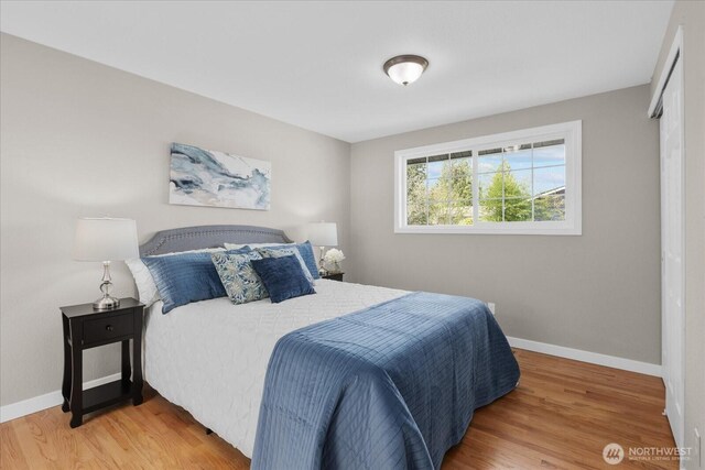 bedroom featuring light wood-style floors and baseboards