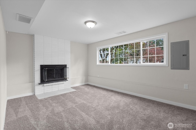 unfurnished living room featuring visible vents, baseboards, carpet, and electric panel
