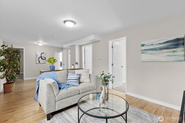 living area featuring light wood finished floors and baseboards