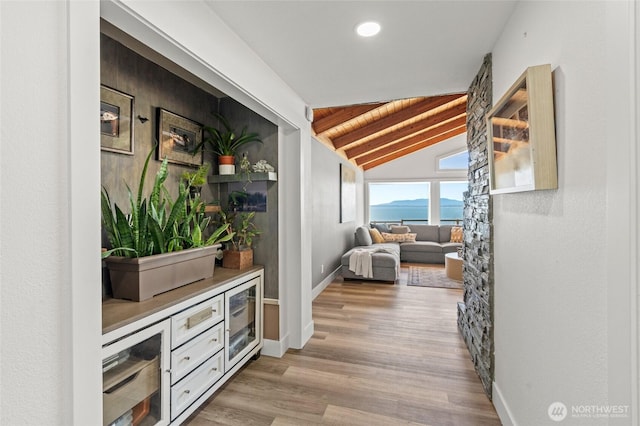 hall with vaulted ceiling with beams, recessed lighting, baseboards, and wood finished floors