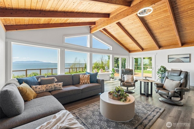 sunroom featuring a water view and beamed ceiling