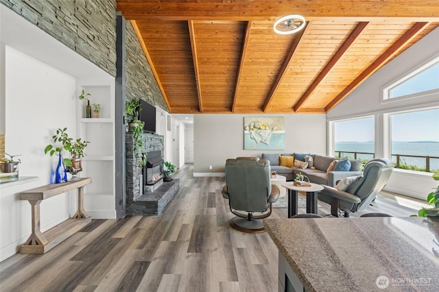 living room with wood ceiling, plenty of natural light, and wood finished floors