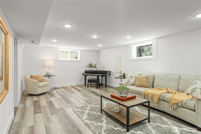 living room featuring recessed lighting, baseboards, visible vents, and light wood finished floors