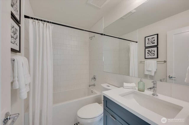 bathroom featuring toilet, shower / bath combo, vanity, and visible vents